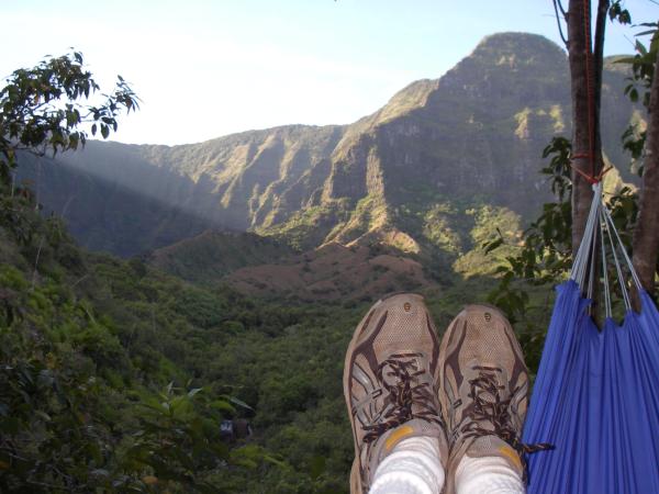 Shafts of light angling into the upper reaches of Kalalau valley and illuminating the south wall, as seen from my hammock