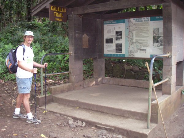 The author in front of a small shelter and trail description